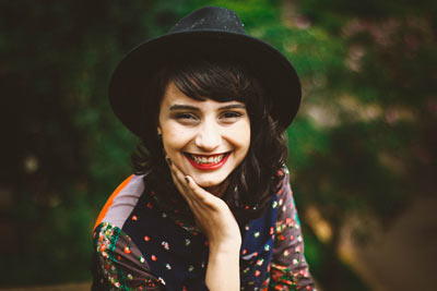 woman in fedora hat smiling